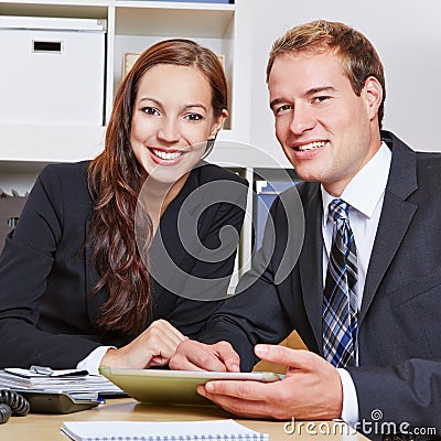 Two happy business people in office