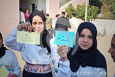 Two Happy Muslim girls holding arabic words