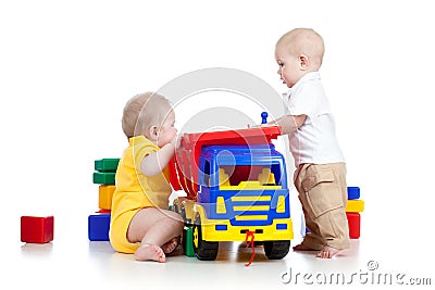 Two little children playing with color toys