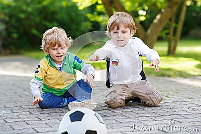 Two little fan boys at public viewing of football game