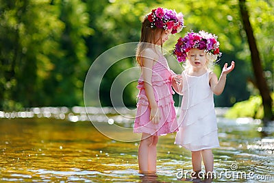 Two little sisters wearing flowers crowns