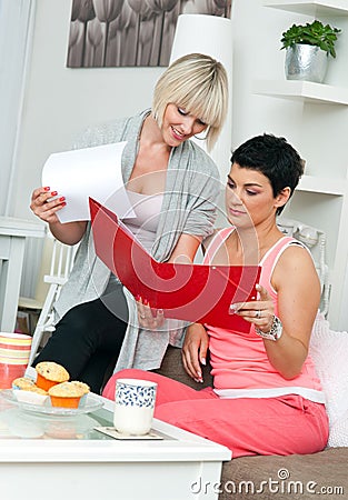 Two mature woman friends working at home