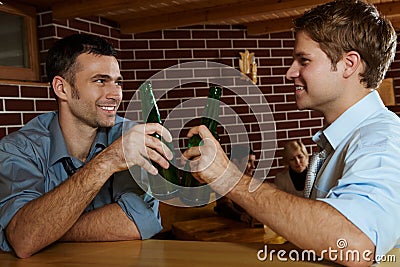 Two men drinking beer in bar