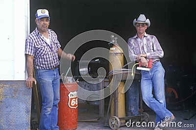 Two men at an old gas station
