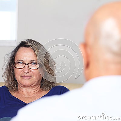 Two older persons talking