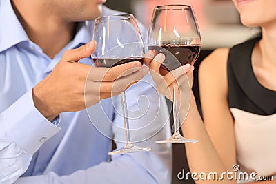Two people toasting with wine glasses.