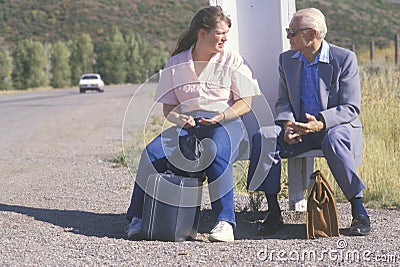 Two people waiting for the bus