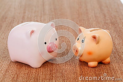 Two piggy banks on table