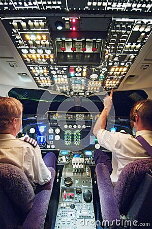 Two pilots in aeroplane cockpit