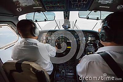 Two pilots inside propeller plane