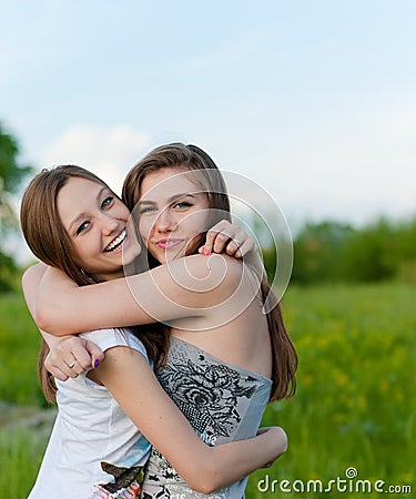 Two pretty Girl Friends Laughing in spring or summer outdoors