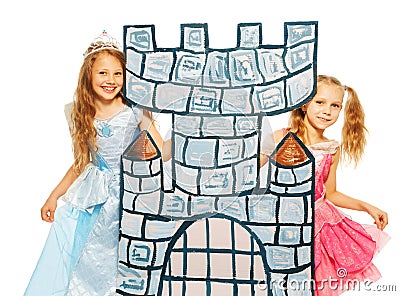 Two princesses behind cardboard castle tower