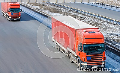 Two red tractor trailer trucks caravan convoy line
