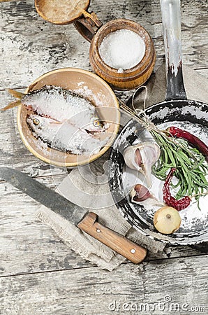 Two roaches fish in ceramic bowl with salt.