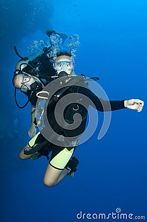 Two scuba divers enjoy a happy dive together