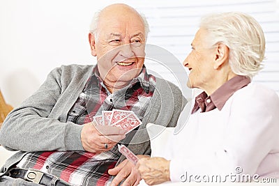 Two senior citizens playing cards