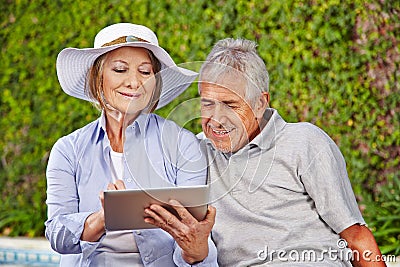 Two senior people with tablet computer