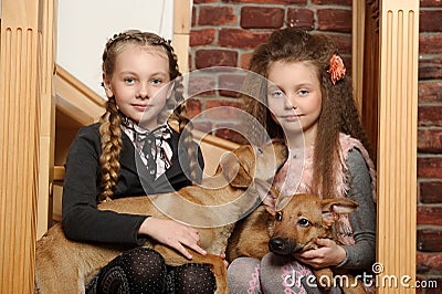 Two sister girls with puppies