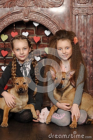 Two sister girls with puppies