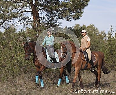 Two smiling girls horseback rides .