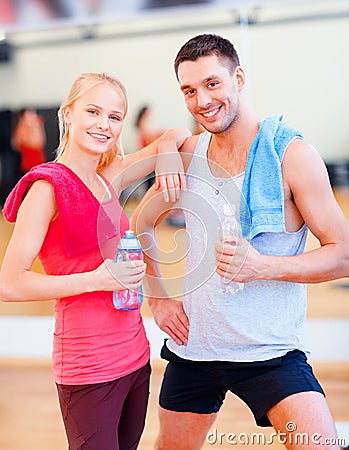 Two smiling people in the gym