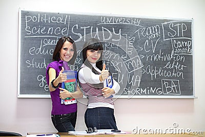 Two students near blackboard
