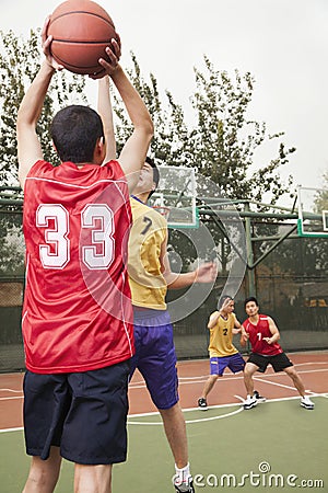 Two teams playing basketball