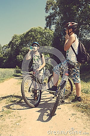 Two teenagers relaxing on a bike trip