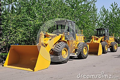 Two wheel loader machine in queue