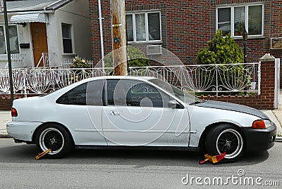 Two wheel locks on an illegally parked car in Brooklyn, NY