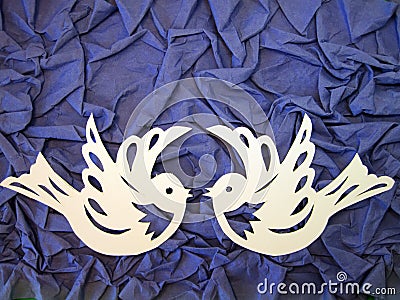 Two white birds. Paper cutting.