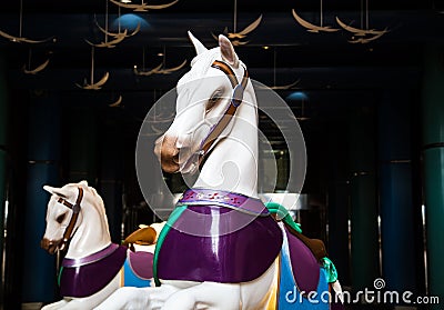 Two White Carousel Horses on Dark Promenade