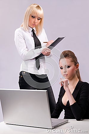 Two women working on a laptop