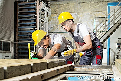 Two workers on a factory