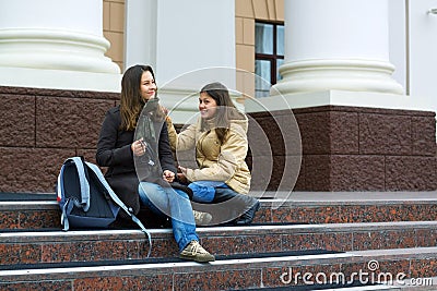 Two young teenage students between classes.