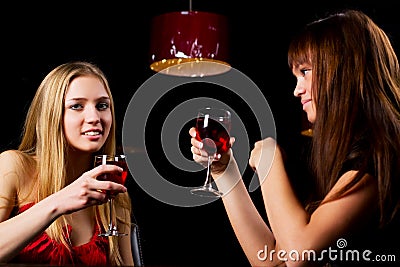 Two young women in a night bar