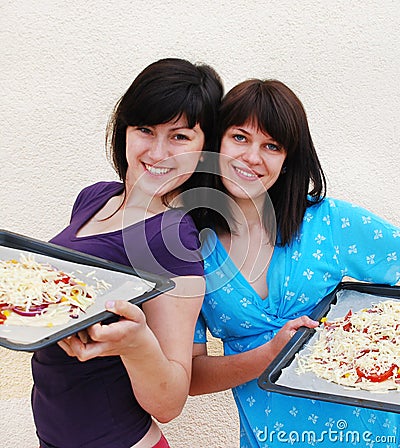 Two young women cooking