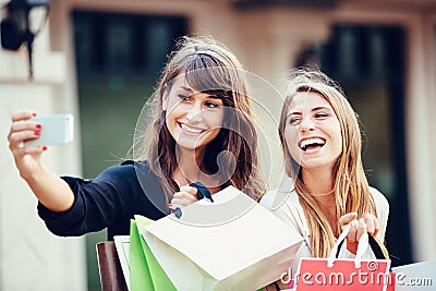 Two young women shopping at the mall taking a selfie