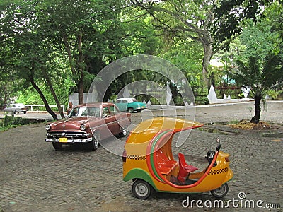 Typical Cuban coco taxi and vintage cars