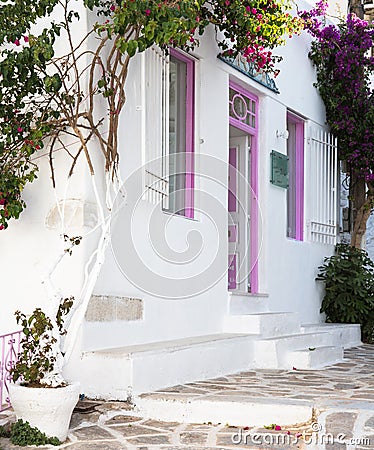 Typical greek house with flowers in the entrance on the cyclades