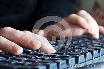 Female hands typing on computer keyboard