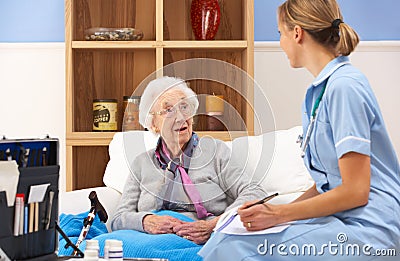 UK nurse visiting senior woman at home