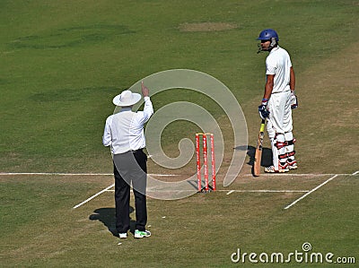 Umpire Singnaling out to a Batsman in Cricket Matc