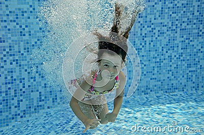 Underwater child jumps to swimming pool