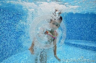 Underwater child jumps to swimming pool