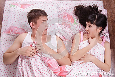 Unfamiliar man and woman wake up in bed
