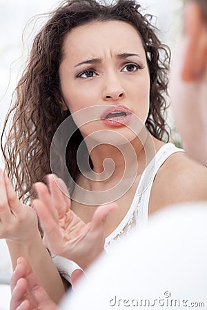 Unhappy young couple in bedroom under stress