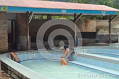 Unidentified boy cleans pools at the hot springs