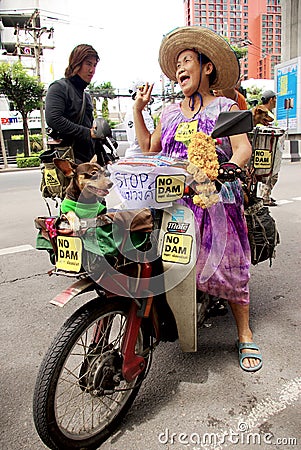 Unidentified old woman with her dog walk for against the construction of a dam in Mae Wong