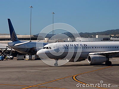 United Airlines Planes sit parked at Airport